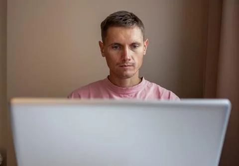 A man using laptop, for distance work at home. Stock Photos