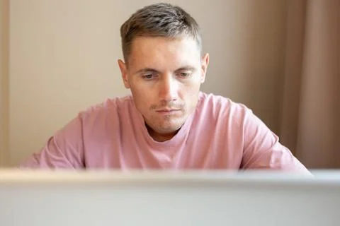 A man using laptop, for distance work at home. Stock Photos