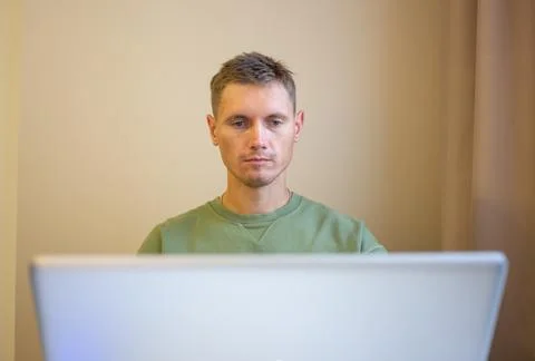 A man using laptop, for distance work at home. Stock Photos