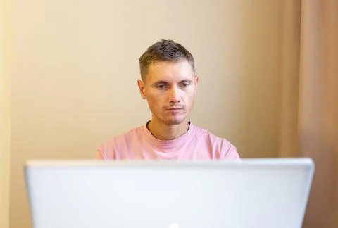 A man using laptop, for distance work at home. Stock Photos
