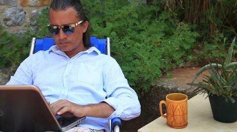 Man using laptop at the garden Stock Footage 53281821