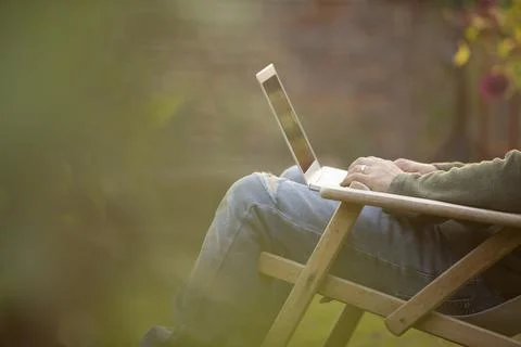 Man using laptop in garden Stock Photos