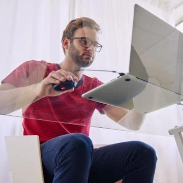 Man using laptop at glass table shot from underneath Fotos Stock