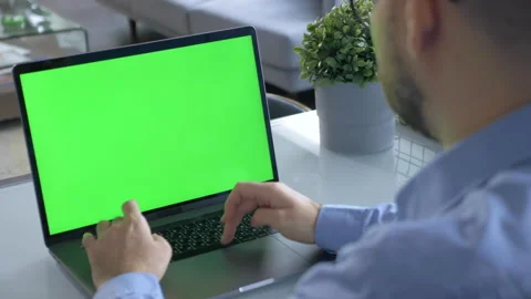 A man using a laptop with a green screen in the office at home Stock Footage 146319702