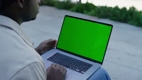 Man using laptop with green screen outdoors Stock Footage 319244288