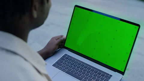 Man using laptop with green screen outdoors Stock Footage 319764651