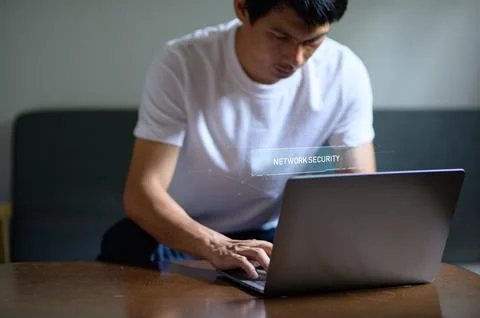 Man Using Laptop with Hologram Display of Network Security Concept Stock-Fotos