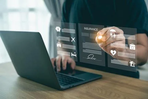 Man using laptop with holographic interface showcasing insurance options, r.. Stockfoto's