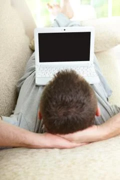 Man using laptop in home Stock Photos