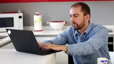 Man using laptop in kitchen. Stock Footage 109398005