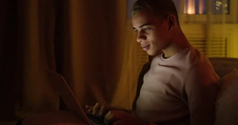 Man using laptop late night at home Video stock 145292206