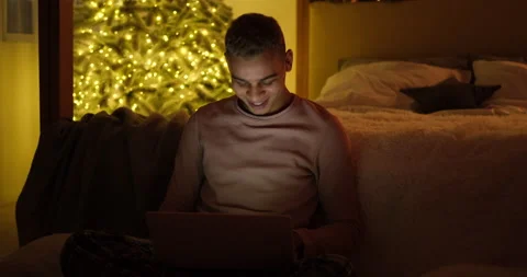 Man using laptop late night in bedroom Stock Footage 145292416