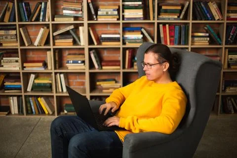 Man using laptop in library. Trendy colors of the year Stock Photos