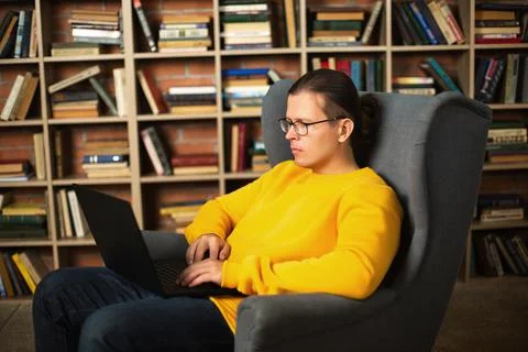Man using laptop in library. Trendy colors of the year Stock Photos