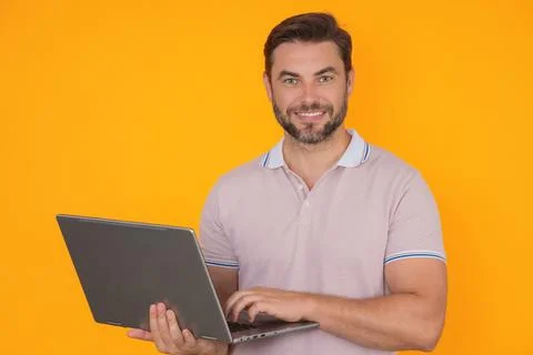 Man using laptop. Man worker watch video on computer laptop. Serious man hold Stock Photos