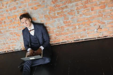 Man using laptop in modern loft, professional businessman in suit working on new Stock Photos