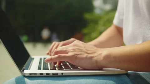 Man using laptop outdoor close-up. Young guy working remotely on computer in Stock Footage 201273962