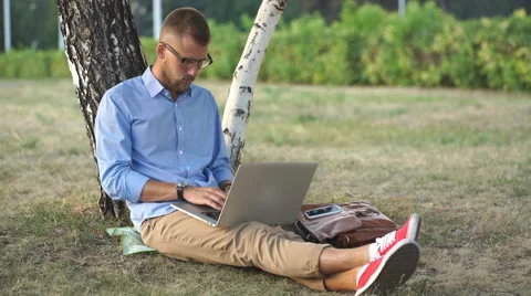 Man using a laptop outdoors Stock Footage 68077923