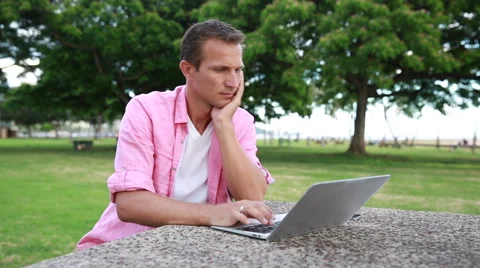 Man Using Laptop In The Park Stock Footage 55618987