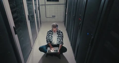 Man Using Laptop in Server Room 스톡 동영상 275570694