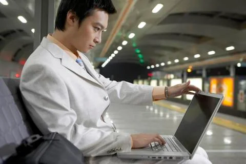 Man Using Laptop Sitting On Couch Stock Photos