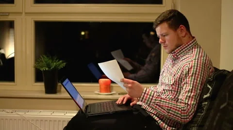 Man using laptop on sofa  Stock Footage 60897892