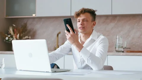 Man using laptop speaking on phone. Stock Footage 206388896