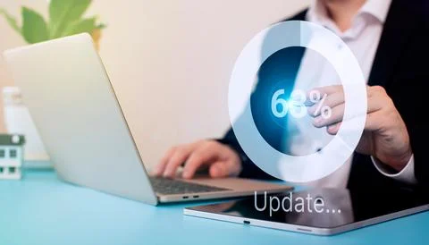 Man using laptop at the table. update the operating system to a newer one. .. 스톡 사진