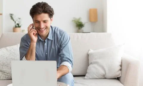 Man Using Laptop Talking On Cellphone With Customer Support Operator Stock Photos