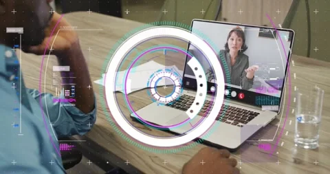Man using laptop touchpad, starting HUD spin while remote woman gesturing and in Stock Footage 321549975