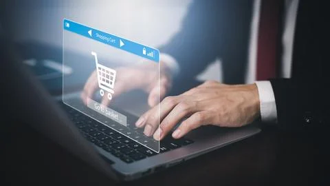 Man using a laptop with typing on a keyboard with online shopping concept, Sh Stock Photos
