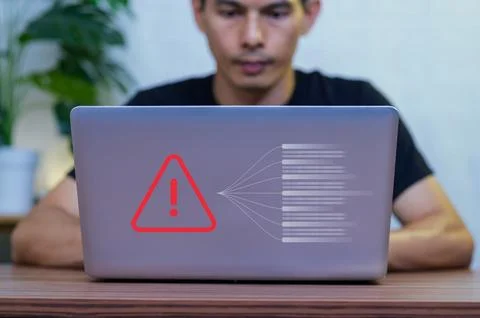 Man Using Laptop with Warning Sign and Data Security Alert Icons Stock Photos