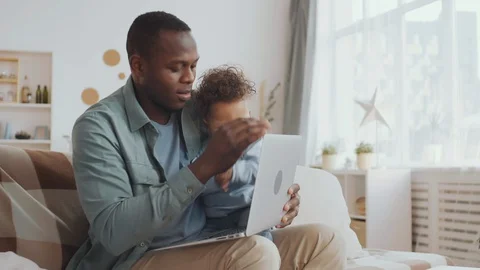 Man Using Laptop while Babysitting Stock-Footage 128287145