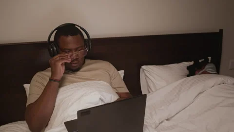 Man Using Laptop while His Wife Sleeping Stock Footage 328518266