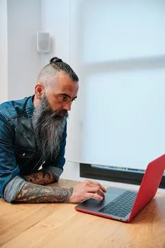Man using a laptop while working in the office. Stock Photos