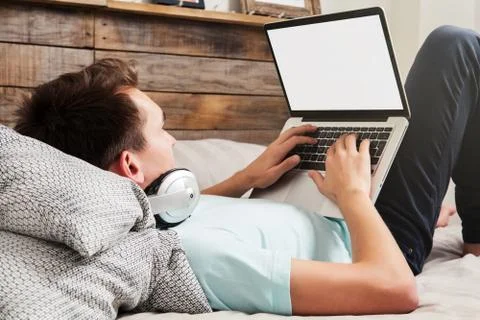 Man using a laptop with white blank screen Stock Photos