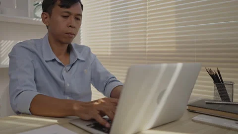 Man using laptop to work on table in office, Press the keyboard on the laptop Stockbeeldmateriaal 263479137