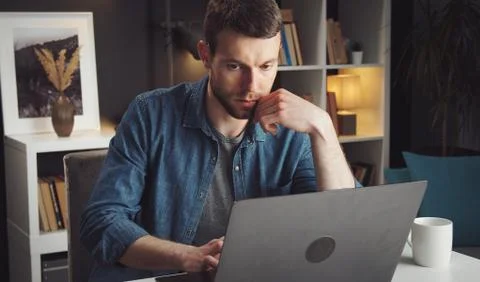 Man using laptop working home Foto stock