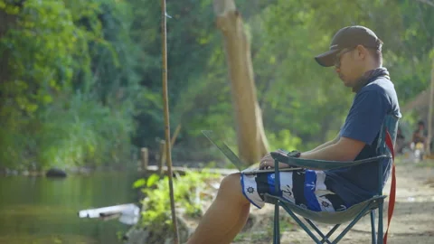 The man using laptop for working while outdoor camping  스톡 동영상 232589785