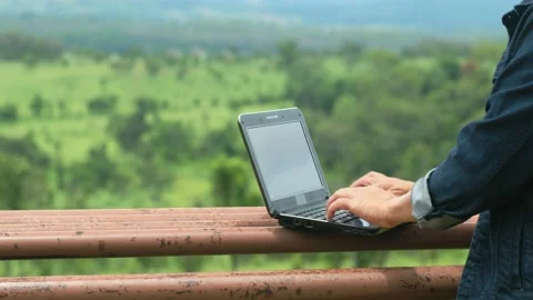 Man using a laptop works in the forest. Effective communication Stock Footage 136523808