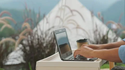 A man using a laptop works in the forest. Stock Footage 136537245