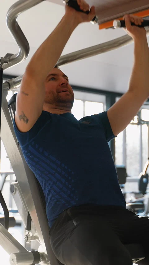 Man using lat pulldown machine at gym Stock Footage 309070319