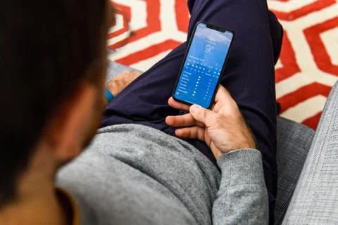 Man using latest iPhone XS unboxing display paris france meteo Stock Photos