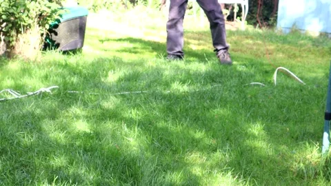 Man Using A Lawn Mower To Cut The Grass Video stock 138110466