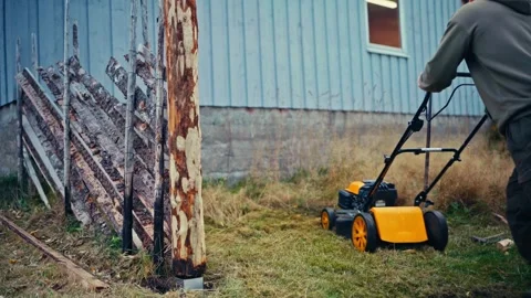 Man Using A Lawnmower Outdoors - Wide Shot Stock-Footage 337013084