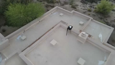 Man using leaf blower to clean roof before pressure washing drone video 4k. Stock Footage 159637509