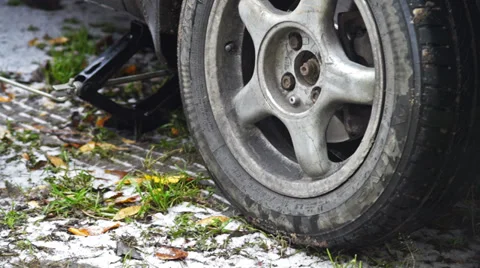 Man using lifting jack for changing tire Stock Footage 32932021