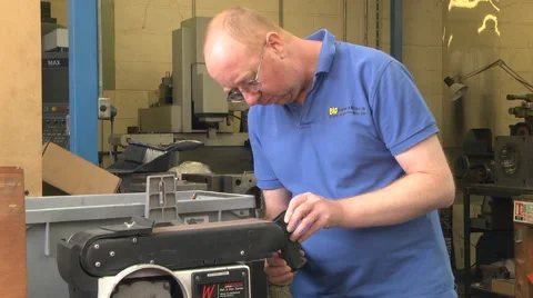 Man using a linisher / belt grinder Stock Footage 46632233