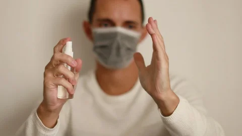 Man using liquid hand sanitizer during quarantine at home Stock Footage 127536225