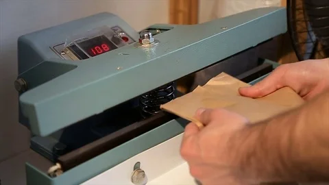 Man using machine specially designed to dispense and package coffee to offer Stock Footage 76346792